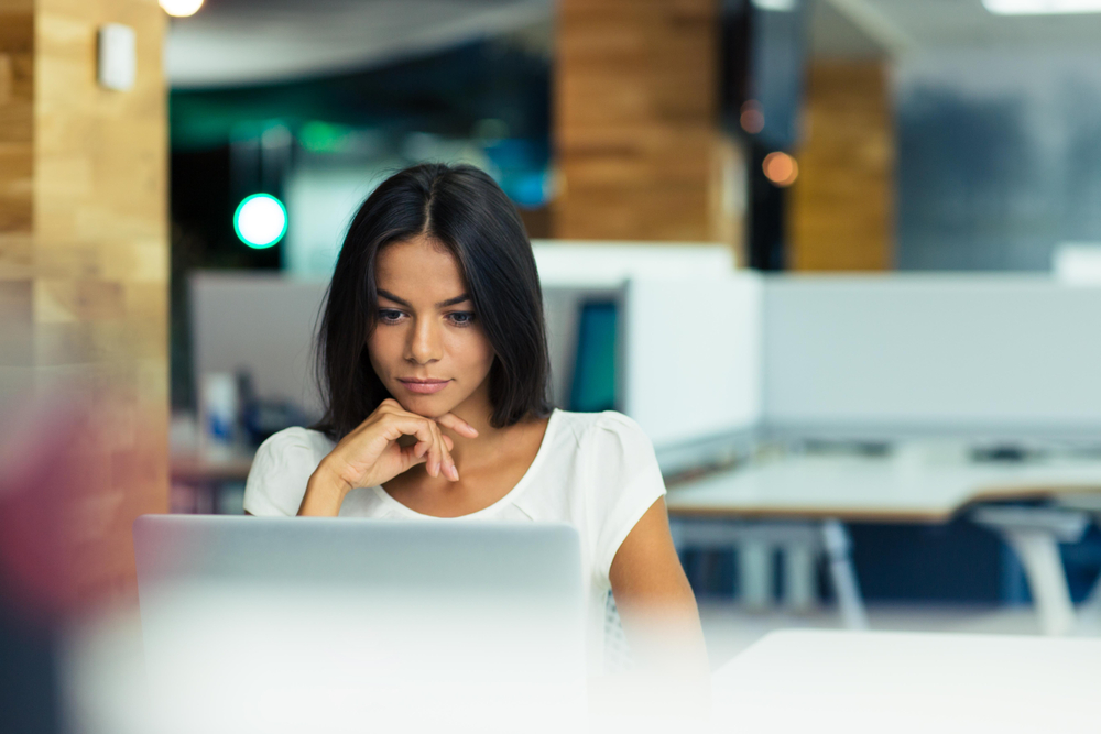 Portrait of a serious businesswoman using laptop in office Portrait of a serious businesswoman using laptop in office